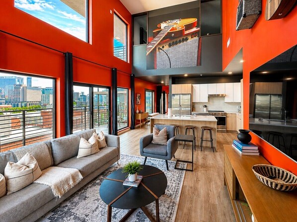 A modern apartment with a living area, kitchen, and dining space.