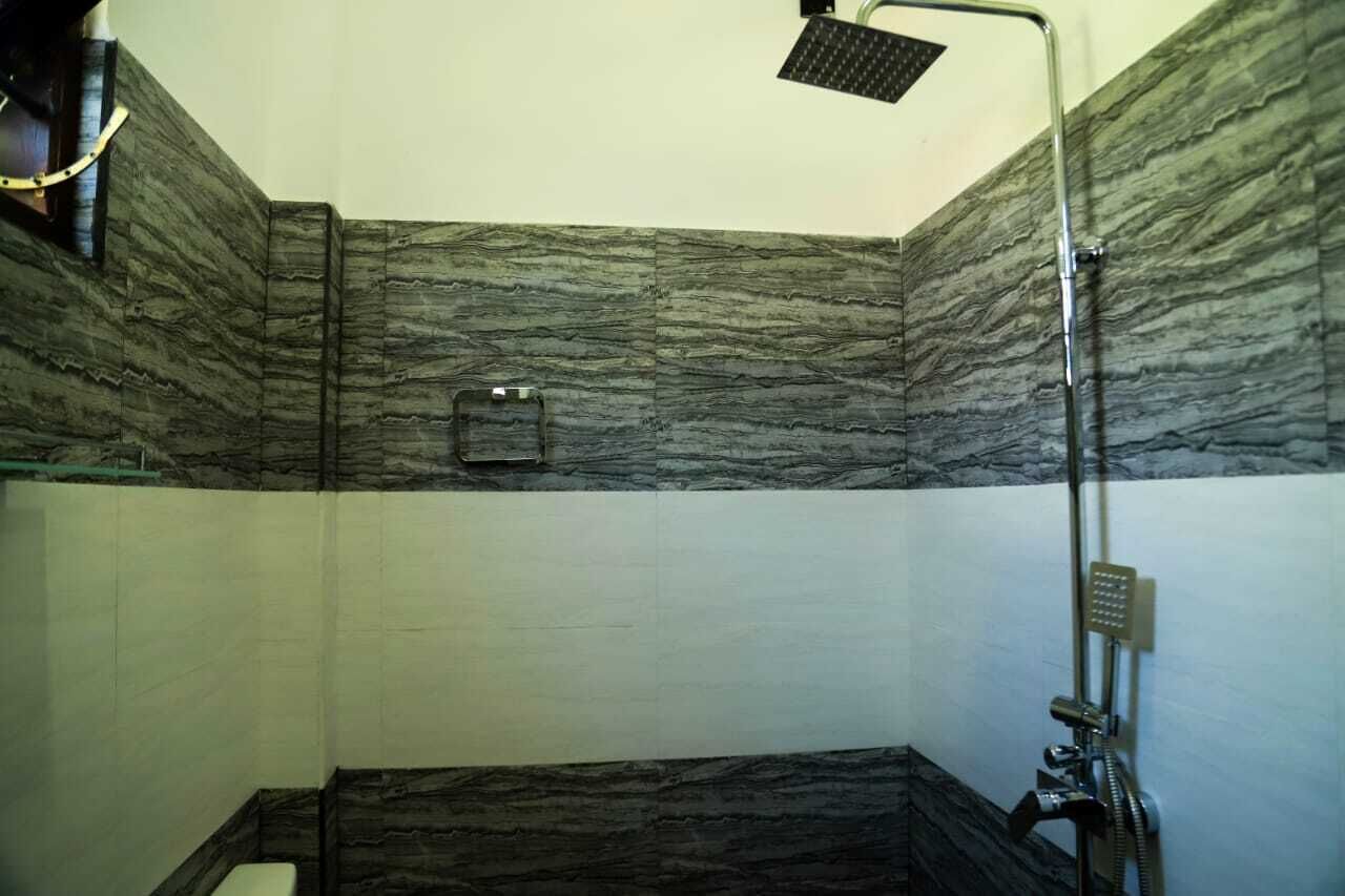 A bathroom with a shower, a toilet, and a sink.