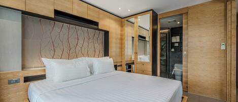 A modern bedroom with a large bed, wooden headboard, and built-in wardrobe.
