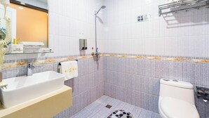 A bathroom with a sink, toilet, and shower.
