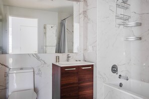Bathroom features a sink, mirror, cabinet, shower, toilet, and bathtub.