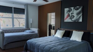 A bedroom with a large bed, a smaller sofa bed, and a window with blinds. - Miami 5BR Pool Home ● BBQ ● Pool ● Coffee Bar ● Kid-Friendly ● Whirlpool Tub (Miami)