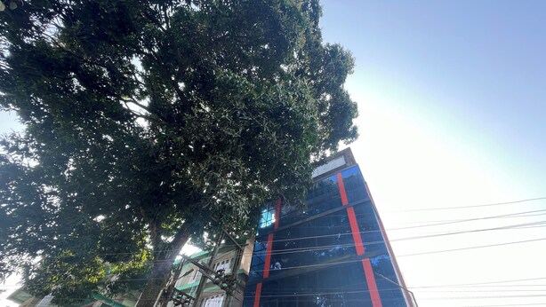 A hotel named "Nondikeshore" with a modern glass facade and red accents.