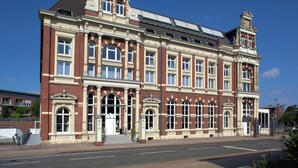 A large, historic building with multiple windows and a prominent entrance. - Bendix weaving mill, junior apartment, 1-3 persons (Dülmen)