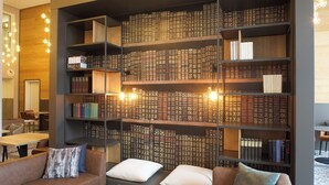 A modern library with bookshelves, a sofa, and a coffee table. - Bendix weaving mill, junior apartment, 1-3 persons (Dülmen)