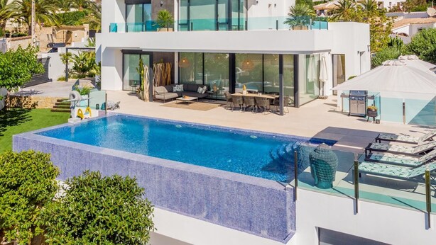 A modern two-story house with a large swimming pool, outdoor seating area, and a view of the surrounding neighborhood. - Casa Amorosa by Solidays - Moraira, Costa Blanca (Moraira)