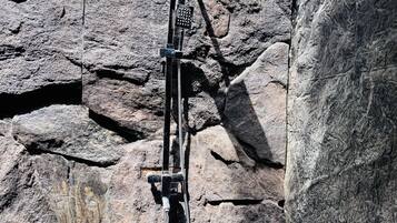 A rock climbing route with a fixed rope and a belay station.