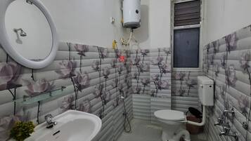 A bathroom with a sink, toilet, and shower.