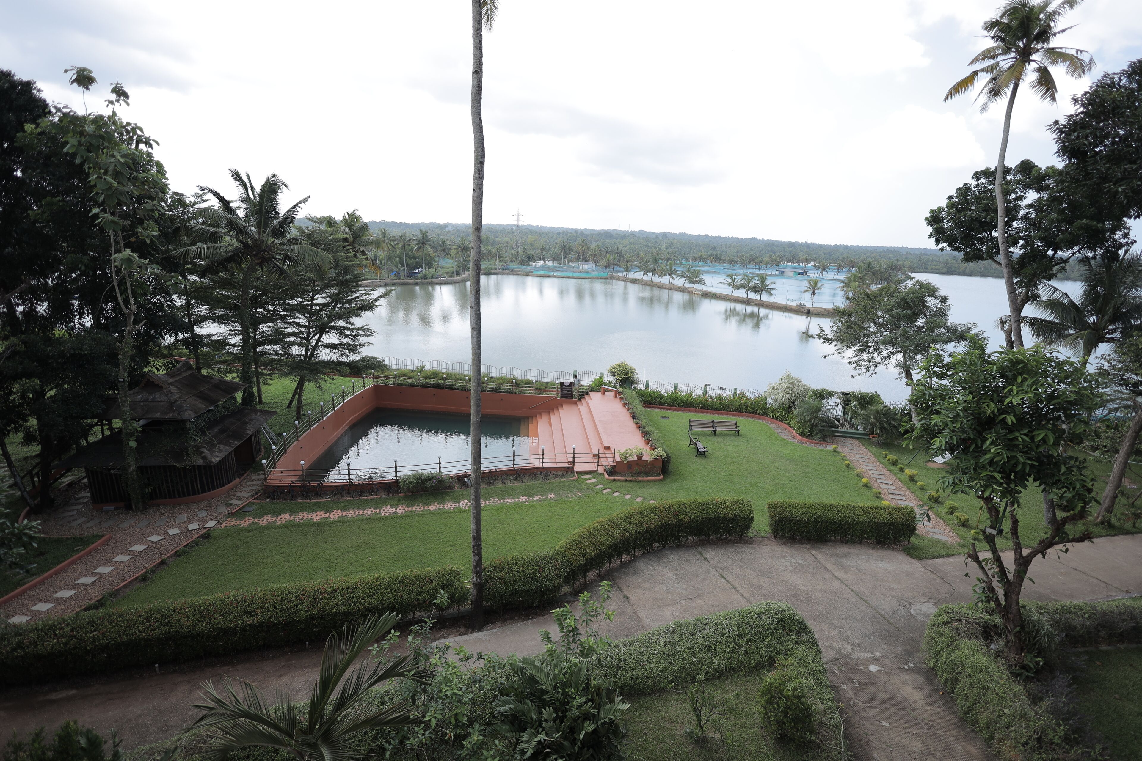 A landscaped area with a water body, pathways, and greenery.