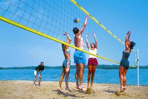 Guests can enjoy a game of beach volleyball on the sandy beach.
