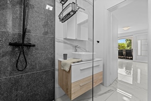 Shower, hair dryer, towels, toilet paper