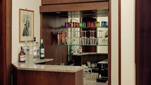 A bar area with a counter, shelves with glassware, and bottles of alcohol. - Da Celeste (Naples)