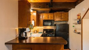 A compact kitchen with wooden cabinets, a microwave, a stove, and a refrigerator. - ‼️Comfy 2BR Getaway Near Lake Grego w/ Mtn Views (Crestline)