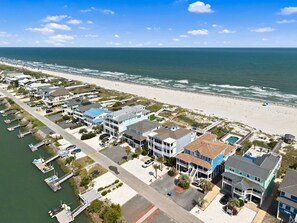 A coastal residential area with beachfront properties, a marina, and a clear view of the ocean. - Shell Yeah- Ocean Isle Beach (Ocean Isle Beach)