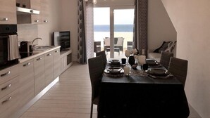 A modern kitchen with a dining area overlooking a balcony. - Sunset Luxury house, beachfront with beautiful view within walking distance to the beach! (La Ciaccia)