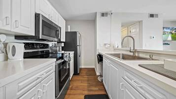 Condo, 1 Queen Bed, Balcony (The Urban Oasis) | Private kitchen | Fridge, microwave, oven, stovetop