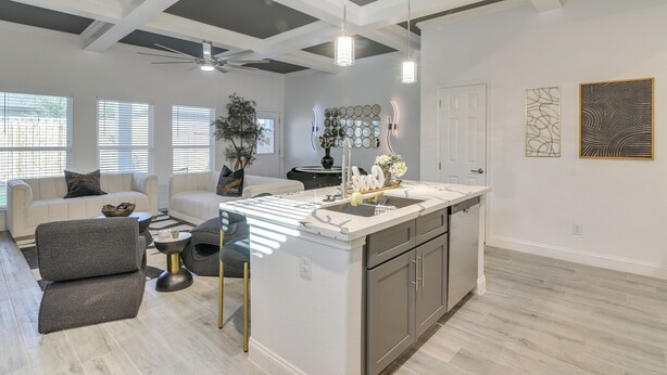 A modern kitchen with a central island, white cabinetry, and pendant lighting. - 4 Mi to NRG Stadium: Luxurious Houston Townhome! (Houston)