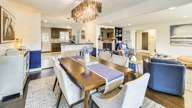 A spacious living room with a large wooden dining table, comfortable seating, and a modern chandelier. - Walk to Powderhouse Polo Fields: Aiken Getaway (Aiken)