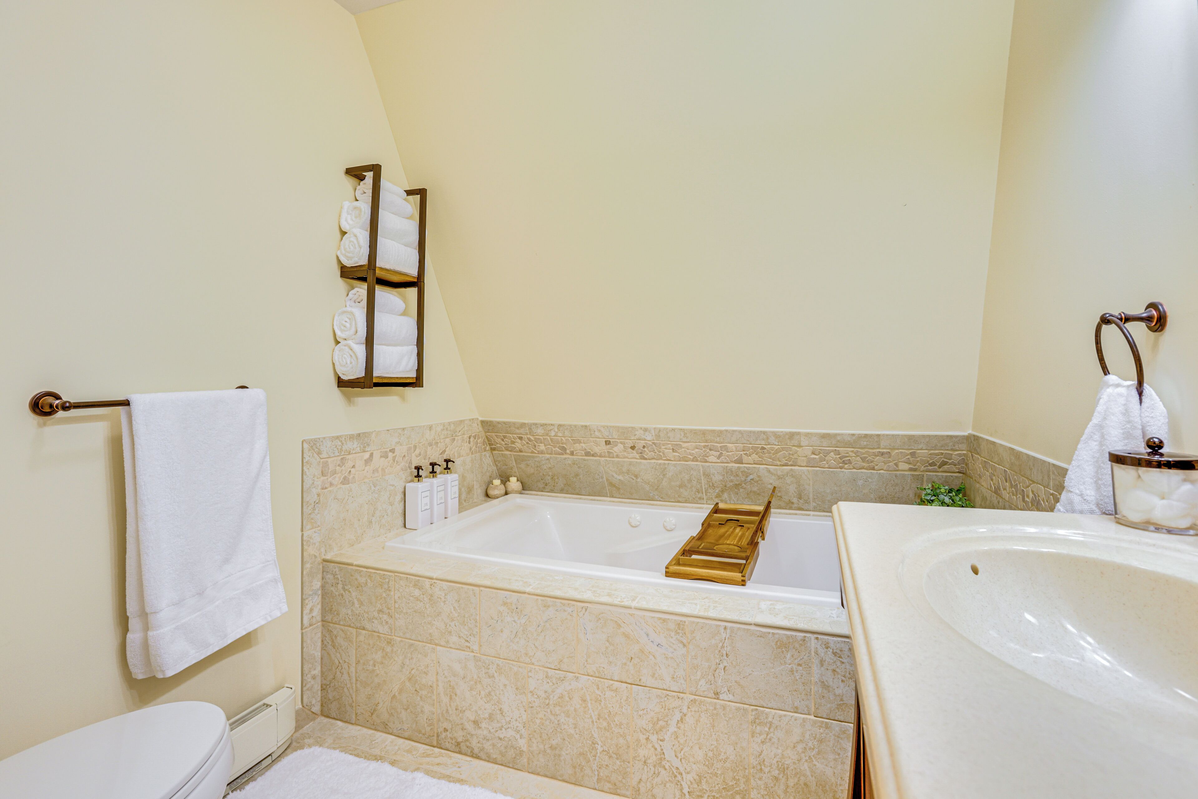 A bathroom with a bathtub, a toilet, and a sink.