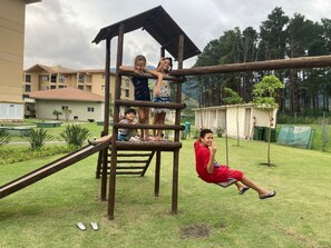 A playground with a wooden climbing structure and a slide. - Reserva do Sahy, Condado (Mangaratiba)