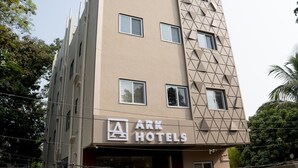 A multi-story hotel with a geometric facade and a sign reading "ARK HOTELS". - ARK Hotels (Ranchi)