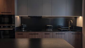 Deluxe Suite, Balcony | Private kitchenette | Full-sized fridge, microwave, oven, stovetop