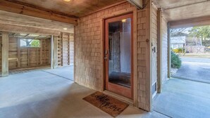 A wooden exterior with a glass door, a concrete floor, and a doormat with "welcome here" text. - Pool, Phenomenal Sunsets Await, Dogs Welcome, Spacious, D0101 (Duck)