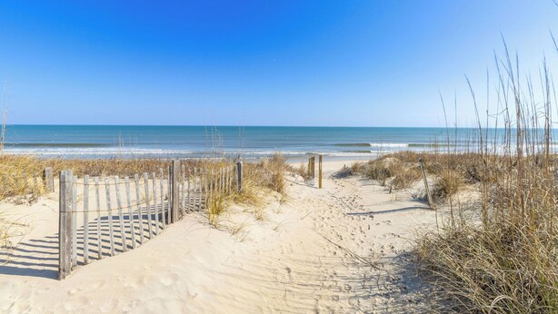 A sandy beach with a wooden fence leading to the water. - Pool, Phenomenal Sunsets Await, Dogs Welcome, Spacious, D0101 (Duck)