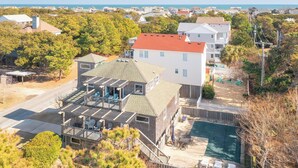 A residential property with a large deck, a swimming pool, and a view of the ocean. - Pool, Phenomenal Sunsets Await, Dogs Welcome, Spacious, D0101 (Duck)