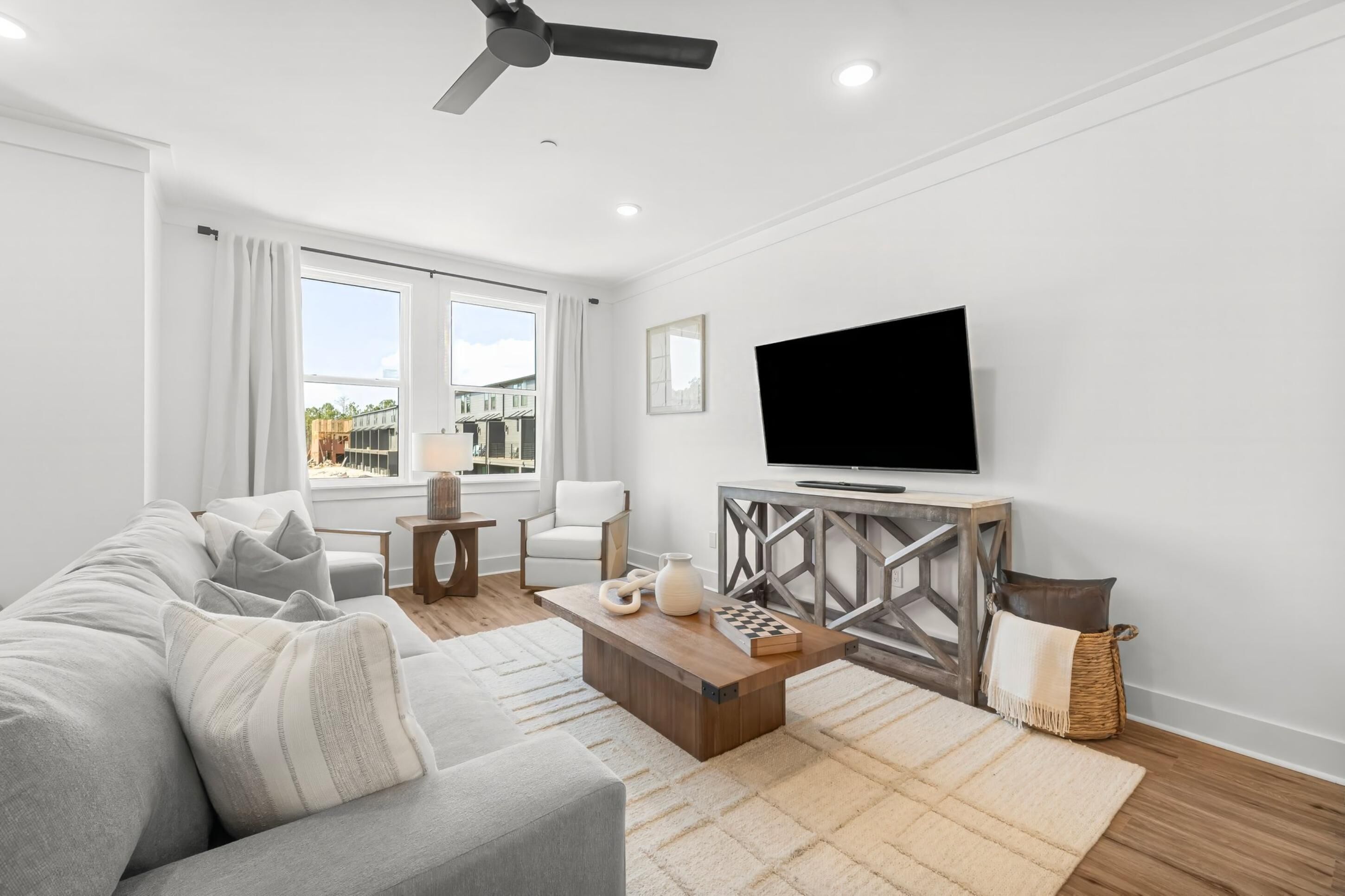 A modern living room with a sofa, coffee table, and TV.