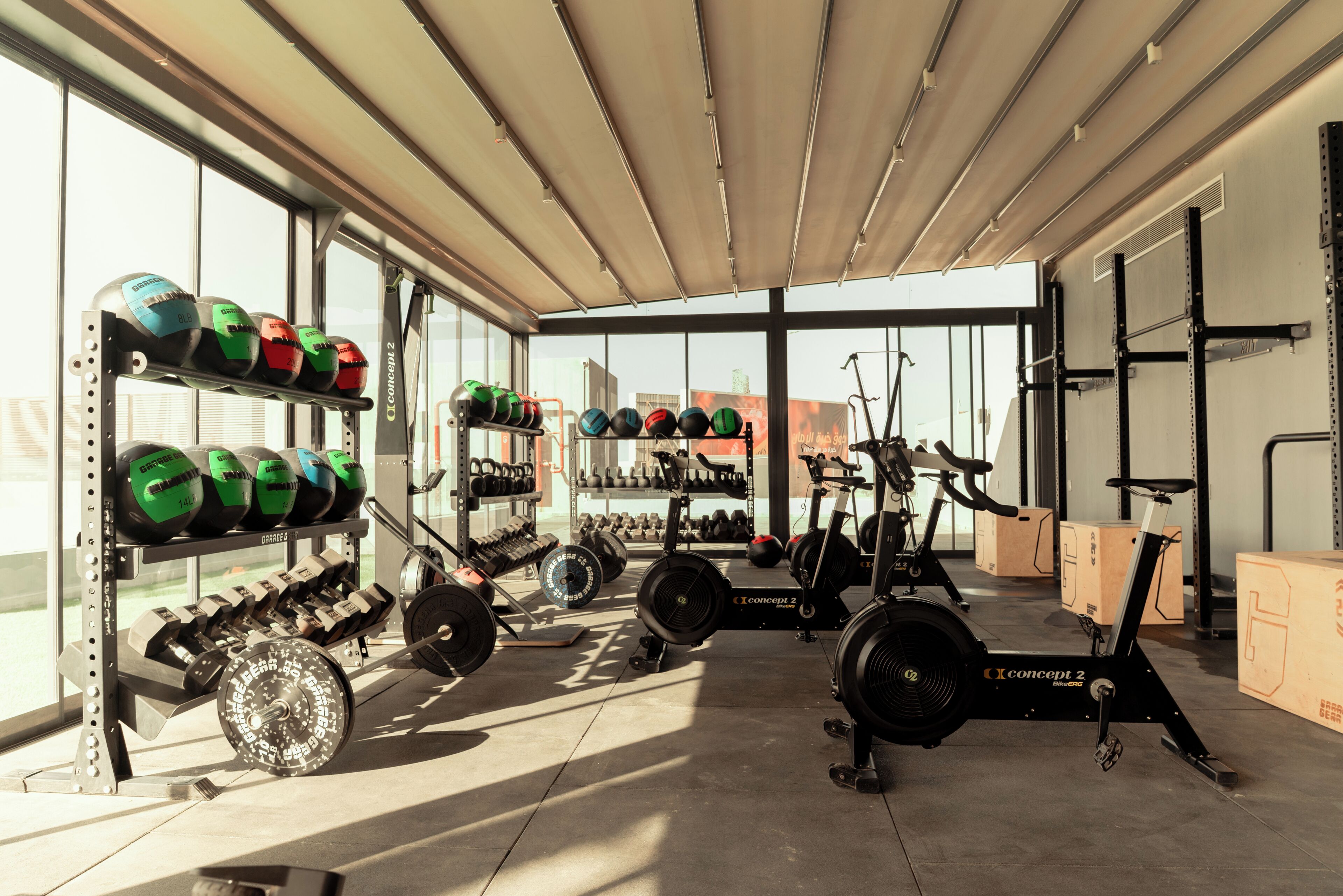 A gym with weightlifting equipment, exercise bikes, and cardio machines.