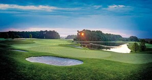 A golf course with bunkers, water hazards, and a sunset. - Bayside Resort: New Listing: Beautiful 4 BR 3.5 Ba (Selbyville)