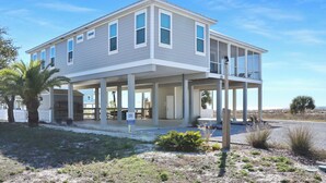 A two-story house with a covered porch and a balcony. - 🌊Beach View-2 Beachfront Screened Decks-4BR-Windchimes🌊 (Mexico Beach)