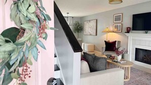 Una sala de estar moderna con chimenea, un sofá, una mesa de centro y un televisor.