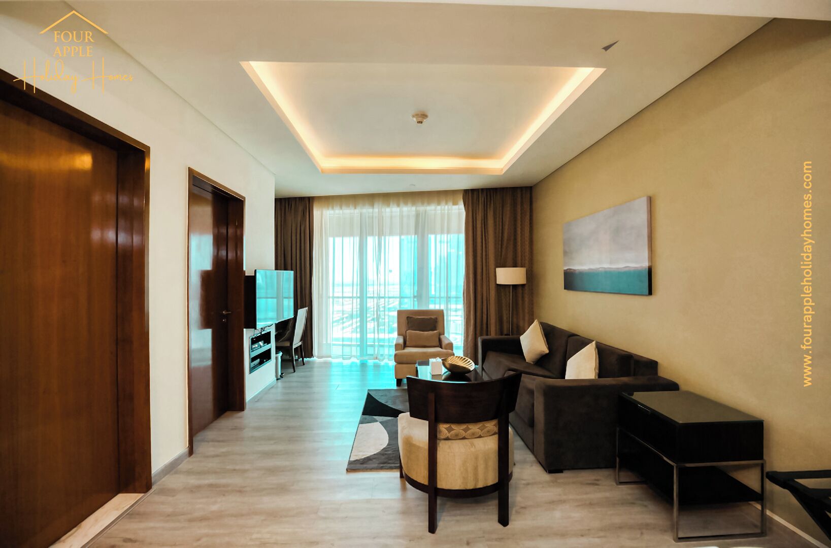 A modern hotel room with a sofa, armchairs, a TV, and a large window offering a view.