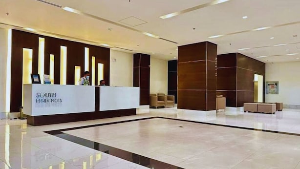 A modern reception area with a reception desk labeled "SOUTH RESIDENCES." There are seating areas with sofas and chairs. - 1BR Covent Garden South Tower University Belt- SM Sta Mesa, Metro Manila,Philippines (Manila)