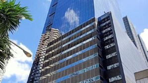 A tall, modern skyscraper with a glass facade and a mix of reflective and matte surfaces. - 1BR Covent Garden South Tower University Belt- SM Sta Mesa, Metro Manila,Philippines (Manila)