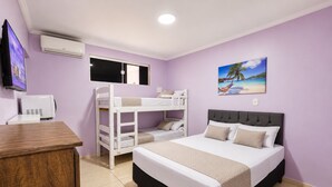 A room with a bunk bed, a desk, and a bed with a headboard. - Alice Suites (Arraial do Cabo)