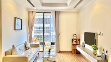 Apartment, 3 Bedrooms | Living area | 50-inch TV with cable channels