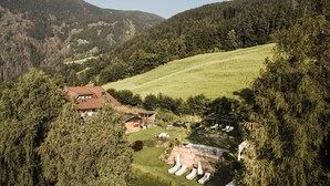 Un chalet de montagne doté d’une piscine, entouré de collines boisées.