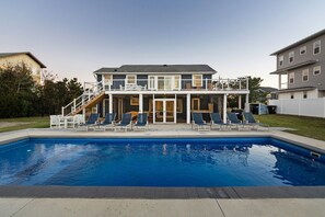 A two-story house with a swimming pool, outdoor seating, and a covered patio. - NEW! Boat Ramp, Pool, Hot Tub (Virginia Beach)
