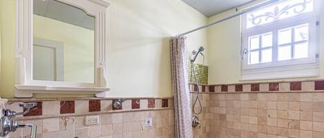 A bathroom with a sink, toilet, and shower.