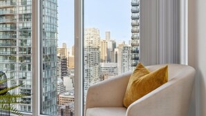 Una sala de estar moderna con un ventanal que ofrece vistas a la ciudad.