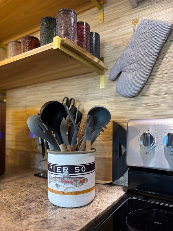A kitchen counter with a canister labeled 'Pier 50' and a stove.