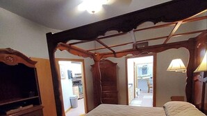 A bedroom with a wooden bed frame, a dresser, and a ceiling fan. - Beautiful brick home w/ large porch and 3 bedrooms (Bowman)