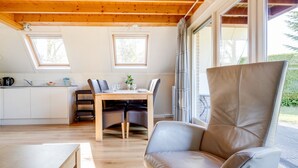 A modern kitchen with a dining area, wooden ceiling, and large windows. - Lovely House I View Garden and Farmland (Zwiggelte)
