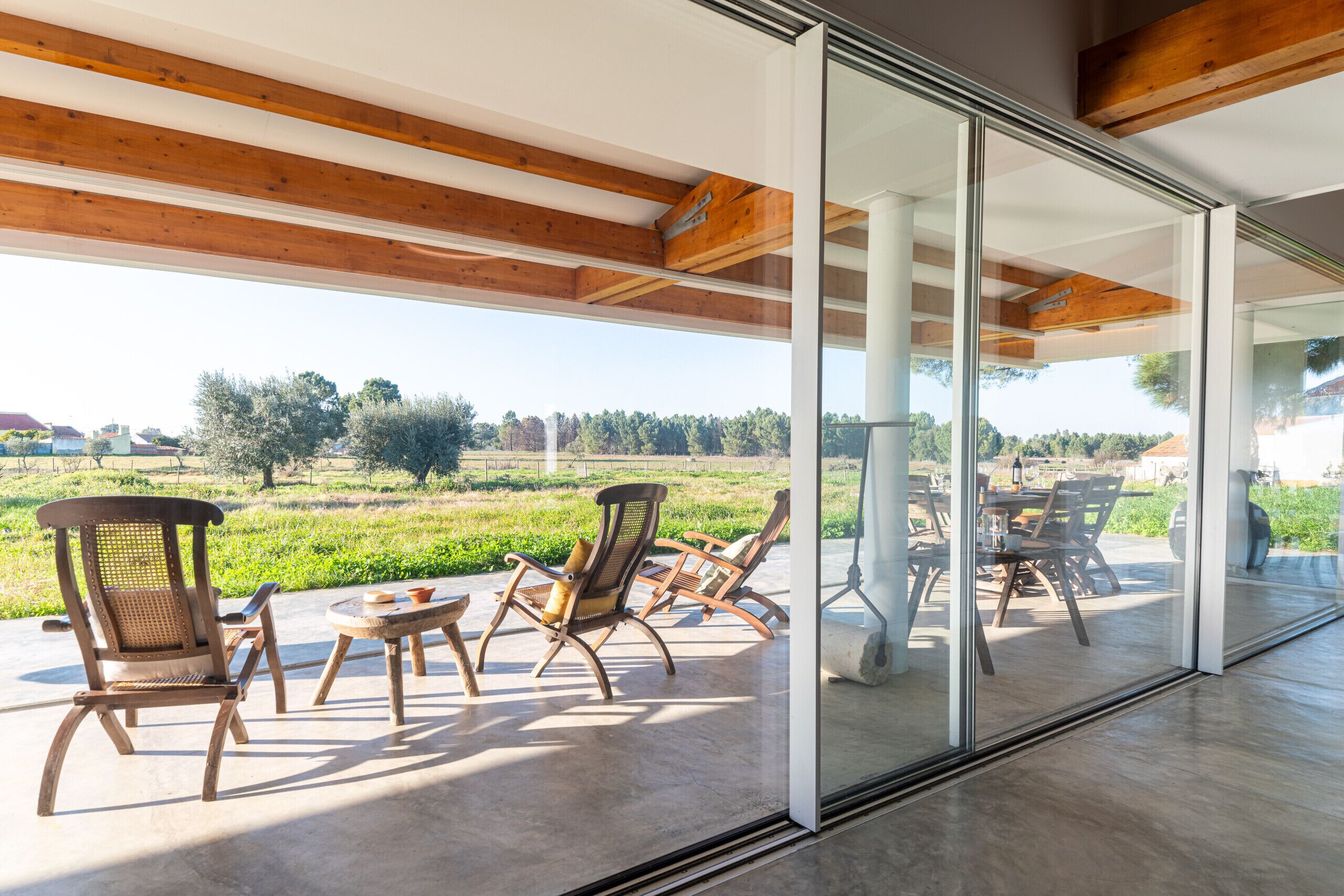 Contemporary terrace with reclining chairs and countryside views — Villa do Pinheiro, luxury holiday villa in Grândola