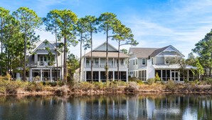 A waterfront property with multiple houses, a dock, and a calm lake.