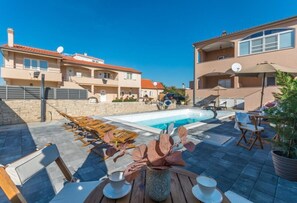 Relax by the pool surrounded by lounge chairs and sunbeds.