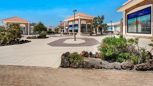 A hotel with a central courtyard, outdoor seating, and a restaurant.
